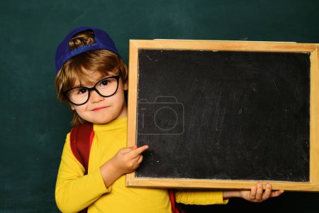 Photo for Happy smiling pupils drawing at the desk. Cheerful smiling child at the blackboard. Classroom. September 1. Back to school - Royalty Free Image