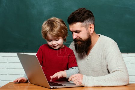 Photo for Education and learning people concept - little student boy and Teacher. Young adult concept. Happy family. Parent Teacher. Daddy Teacher. First day in school - Royalty Free Image