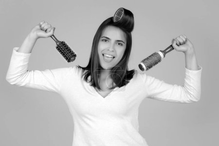 Photo for Funny woman combs her healthy hair. Combing healthy long straight female hair, close up - Royalty Free Image