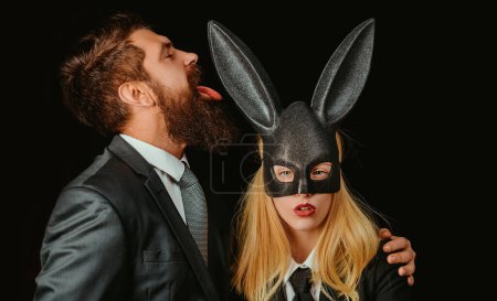 Photo for Bunny mask woman. Serious man with beard. Rabbit and girl. Lovely woman in rabbit costume. Stylish man. Young girl easter woman in bunny ears - Royalty Free Image