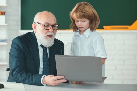 Photo for Back to school. Teacher and child with laptop. Online education and learning concept. Schoolboy in classroom - Royalty Free Image