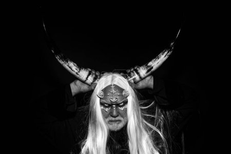 Photo for Demon head isolated on black. Man with a bull head. Bearded old man dressed like Halloween monster. Vampire man with white eyes. Ancient alchemy. Viking with a horned head - Royalty Free Image
