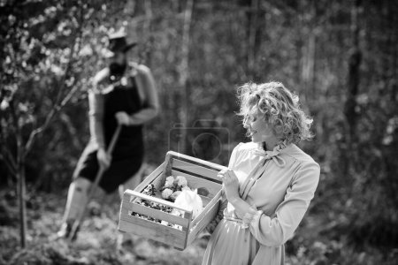 Photo for Lifestyle and family life. Image of two happy farmers with instruments. I like spending time on farm. Two people walking in agricultural field - Royalty Free Image