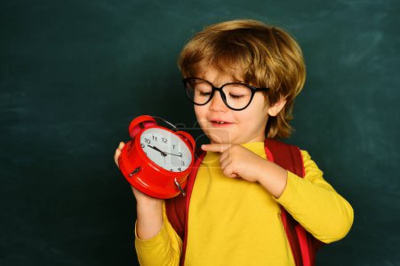 Photo for Back to school. Alarm clock anxiety. Late. Kid boy holding clock alarm - Royalty Free Image