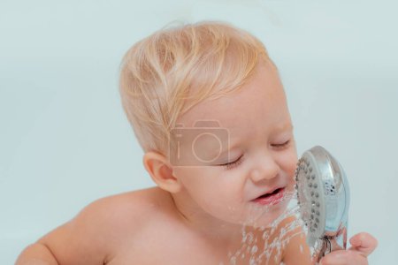 Photo for Happy little boy in bath. Little baby washing with a bubbles. Bubble bath. Bubble Bath time - Royalty Free Image