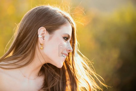 Photo for Young woman outdoor enjoying the sunlight. Outdoor portrait of a cute girl. Happy cheerful female model, close up face. Woman with romantic smile - Royalty Free Image