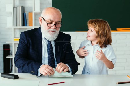 Photo for School break with teacher. Schoolboy with airplanes. Education, teachering, learning. Pupil in classroom - Royalty Free Image