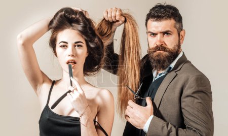 Brutal guy in modern Barber Shop. Hair Preparation is just for the dashing chap. Hair Studios. Beauty woman getting haircut by hairdresser at barbershop hairstudios