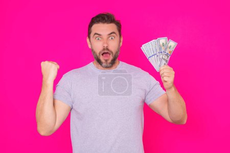 Photo for Man with money cash. Dollar banknotes. Portrait of man holding bunch of money banknotes. Dollar bills, credit, online banking. Rich man pointing at dollar banknotes, bank loan, financial savings - Royalty Free Image