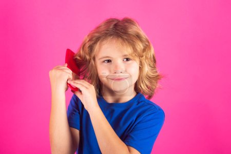 Photo for Morning kids after shower. Child with tangled blonde long hair tries to comb it. Hair portrait kid with a comb - Royalty Free Image