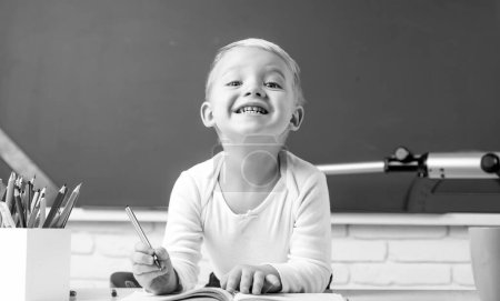 Photo for Portrait of funny Pupil in classroom. Elementary school and education. Individual tutoring - Royalty Free Image