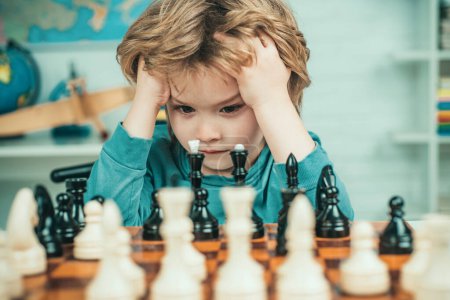 Photo for Pupil kid thinking about his next move in a game of chess. Clever concentrated and thinking child while playing chess. Little clever boy thinking about chess. Games good for brain intelligence concept - Royalty Free Image