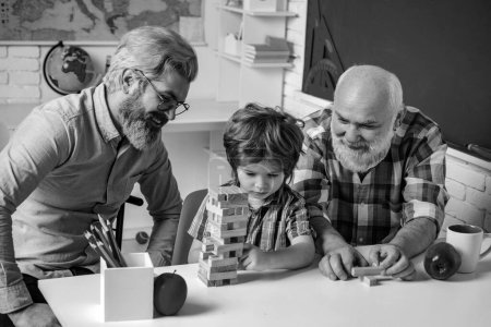 Photo for Happiness family life style concept. Father and son with grandfather was excited with playing game. Playing Jenga - Royalty Free Image