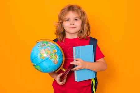 Photo for Studio portrait of school child. School boy world globe and book. School kid 7-8 years old with book go back to school. Little student. Education concept - Royalty Free Image