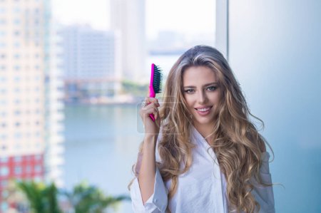 Photo for Beautiful woman with brush combing hair. Beauty girl with straight hair isolated on balcony terrace. Woman hold hairbrush near face. Healthy hair. Hairstyle and hair care concept. Morning hairs care - Royalty Free Image