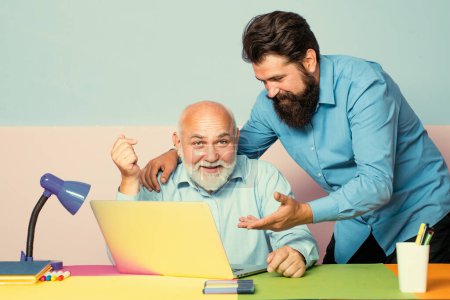 Photo for World teachers day. Educational process. Man with old teacher learning in class on color background. Father and son - Royalty Free Image