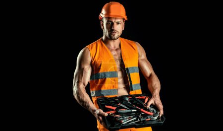 Foto de Reparador con casco de construcción mantenga herramientas de construcción. Trabajador profesional hombre - Imagen libre de derechos