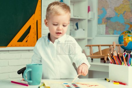 Photo for Educational process. Home study. Learning and education concept. After school teaching. Cute child 3 year old in classroom near blackboard desk - Royalty Free Image