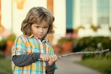 Photo for Child negative aggression. Kids emotion concept. Angry boy with stick. Kid adaptation. Bully. Bullying concept. nervous breakdown - Royalty Free Image