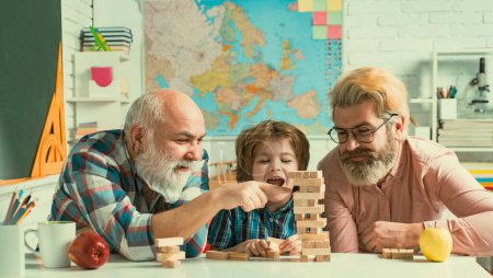 Photo for Grandfather father and son spending weekend together. Happy men loving family. Man family Playing Jenga - Royalty Free Image