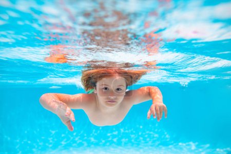 Photo for Child in pool in summer day. Child boy swim under water in sea. Kid swimming in pool underwater. Happy boy swims in sea underwater, active kid swimming, playing and diving, children water sport - Royalty Free Image
