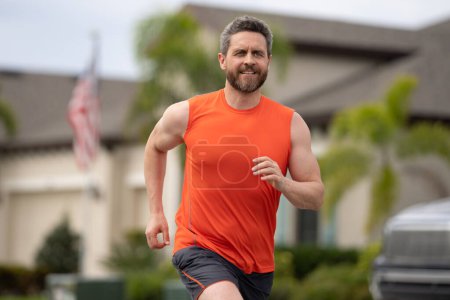 Photo for Sport runner. Man running. Fit male sport fitness model sprinting outdoors. Attractive man running fast, workout outdoors, runner jogging over american street - Royalty Free Image