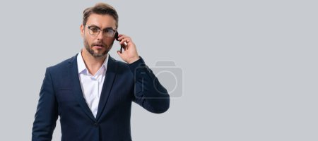 Photo for Man in suit using smart phone. Portrait attractive cheerful guy using phone, calling on mobile phone. Handsome man with smart phoneon studio isolated background. Banner, copy space - Royalty Free Image