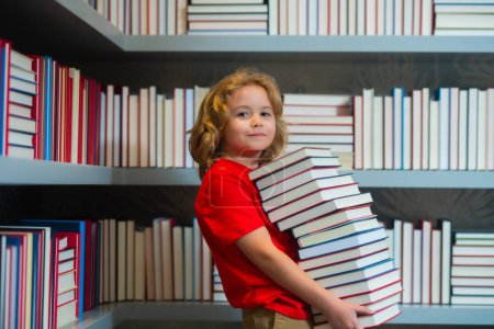 Photo for School kid with pile of books. Children enjoying book story in school library. Kids imagination, interest to literature. Kids smart activity. Child study read book in classroom - Royalty Free Image