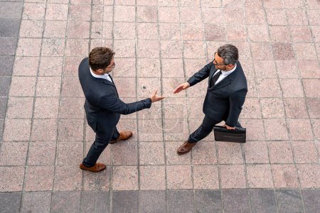 Photo for Business man shaking hands. Two businessmen handshake outdoor. Handshake business people. Businessmen communicating at meeting. Handshake of two business man in suit top view - Royalty Free Image