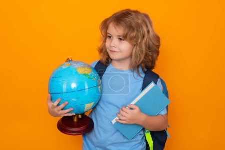 Photo for Smart child, clever school kid. School boy with world globe and book. Kid boy from elementary school. Little student, smart nerd pupil ready to study. Concept of knowledge, education and learning. - Royalty Free Image