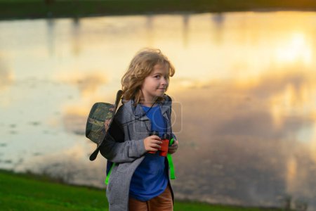 Photo for Kid with binoculars hiking at nature. Little explorer. Outdoor recreation and adventures with kids. Child tourist on sunny countryside background - Royalty Free Image