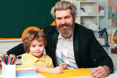 Photo for Preschool tutorship. Young happy family father and son schooling math together - Royalty Free Image