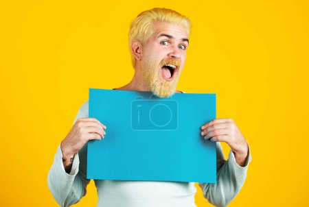Photo for Happy Man holding big sign board. Red head man holding a banner. Men showing empty board with copy space for advertisement - Royalty Free Image