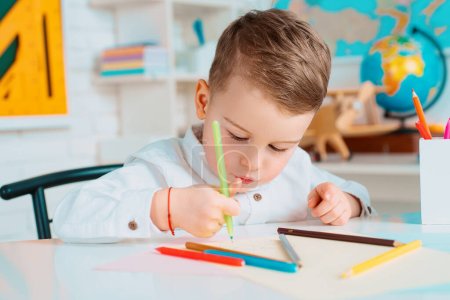 Photo for Back to school. Pupil drawing at the desk. Child in the class room. Kid from primary school - Royalty Free Image