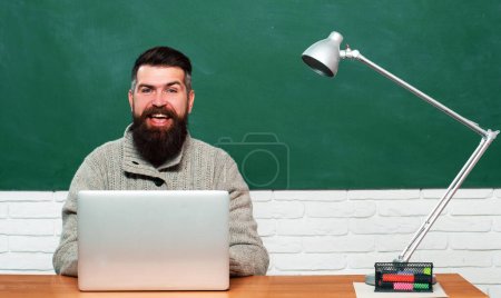 Photo for Tutor. Preparing for exam in college. Young teacher near chalkboard in school classroom. Science and education concept - Royalty Free Image