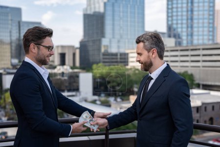 Photo for Two business team men. Businessmen giving money. Business man offering money for collage. Offering money for business - Royalty Free Image