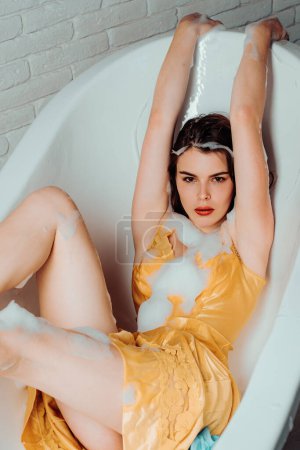 Photo for Beautiful woman in a bubble bath. Woman in the bathroom. Sexy vogue woman face, sensual beauty girl model - Royalty Free Image