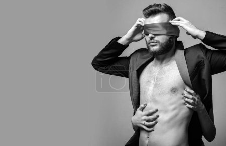 Photo for Awakening his desire. Female tease guy. Macho well groomed hipster nude torso tied eyes red ribbon. Sexual relations. Sex game. Tease and seduce. Passionate lovers. Sex domination. Sex submission. - Royalty Free Image