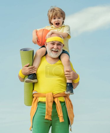 Photo for Elderly sporty man and young boy sporting morning workout - copy space. Healthy family lifestyle. Sport yoga and fitness. Rehabilitation - Royalty Free Image