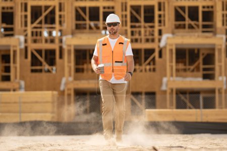 Photo for Construction worker with hardhat helmet on construction site. Construction engineer worker in builder uniform on construction. Portrait of builder ready to build new house - Royalty Free Image
