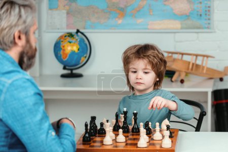 Photo for Child chess school. Preschooler or schoolboy, Boy kid playing chess at home. Games and activities for children. Family concept - Royalty Free Image