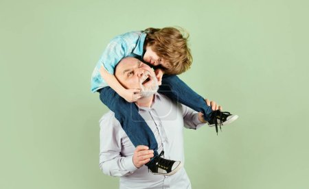 Photo for Grandfather carries grandson on shoulders on green background isolated. Men generation - Royalty Free Image