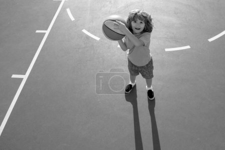 Foto de Lindo niño pequeño entrenamiento de baloncesto. Escuela de baloncesto infantil - Imagen libre de derechos