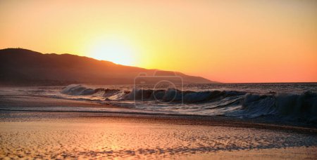 Photo for Sunset with large yellow sun under the sea surface. Calm ocean with sunset sky and sun through the clouds over. Abstract background with sunset and ocean - Royalty Free Image