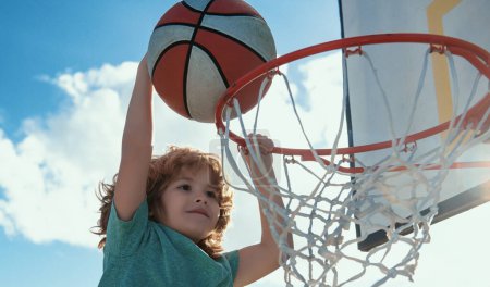 Photo for Kids little boy playing basketball. Child sport activity - Royalty Free Image