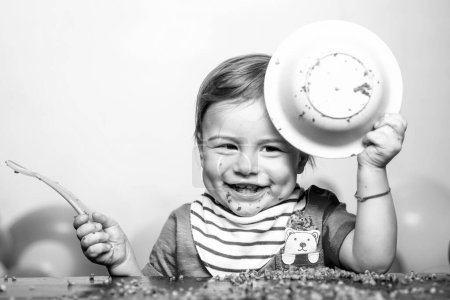 Photo for Baby eating, Funny baby face with plate - Royalty Free Image