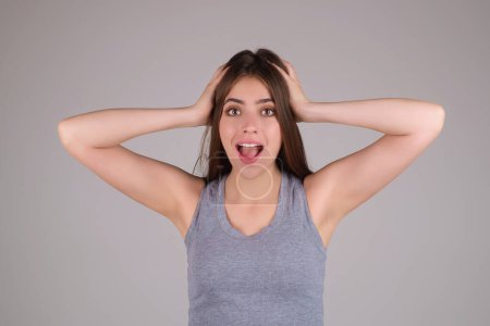 Photo for Emotional student girl shocked with news covering mouth with hands. Young emotional woman. The human emotions, facial expression concept. Amazed girl with shocked facial expression - Royalty Free Image