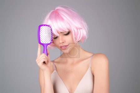 Photo for Young woman combing hair. Beautiful woman brush healthy hairs. Hairstyle and haircare concept. Girl combing and brushing hair in studio. Woman with comb combing hair. Hair brush - Royalty Free Image