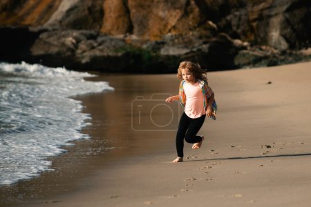 Photo for Little athlete in training. Runner exercising, jogging for kids. Child run at seaside. Kids running on beach. Summer vacation. Happy kid boy playing on beach. Happy childhood - Royalty Free Image