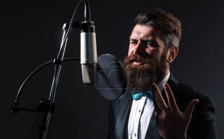 Foto de Cantante cantando música clásica. Productor de sonido grabando una canción en un estudio de música. Emocionado Karaoke - Imagen libre de derechos